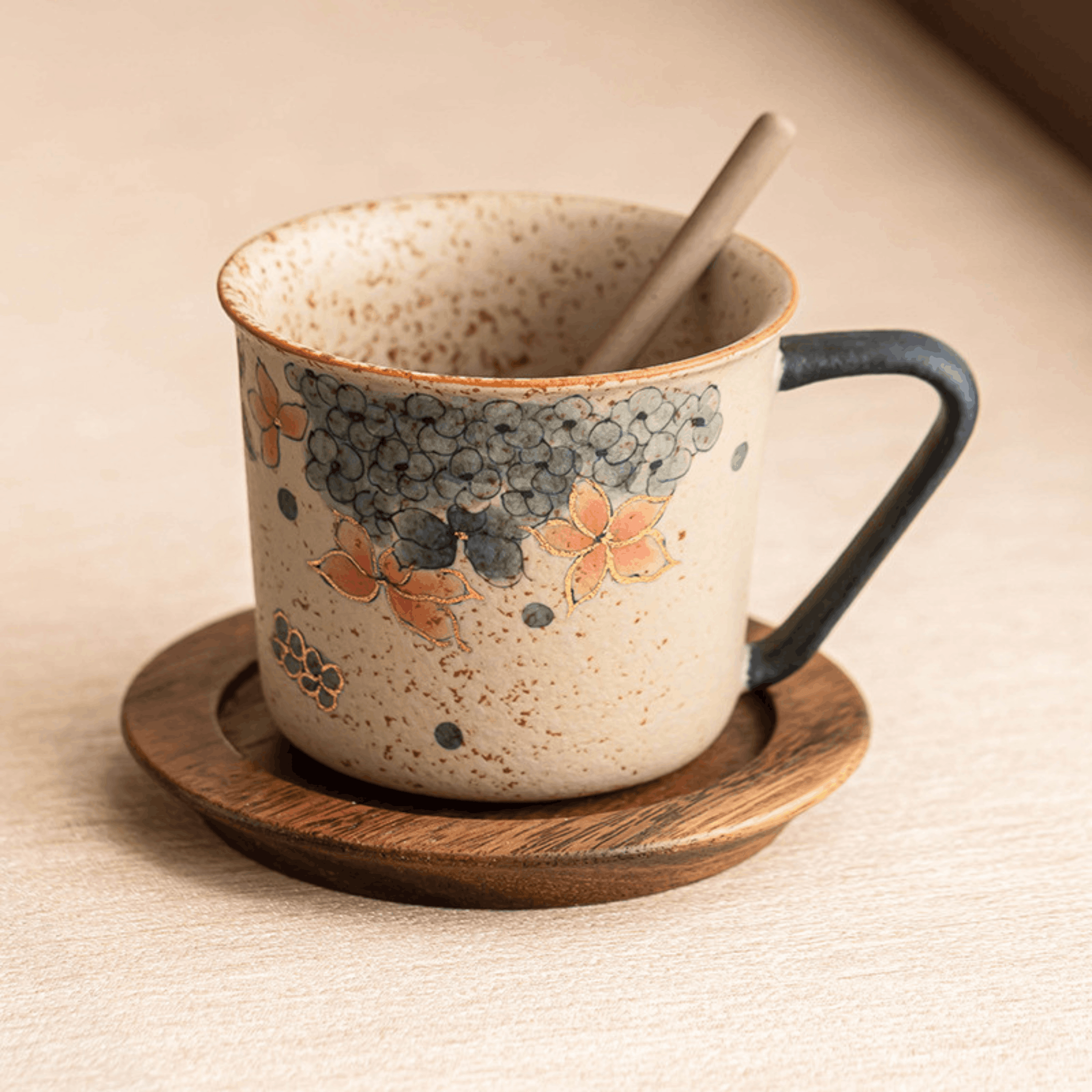 Ceramic mug with floral design on a wooden coaster