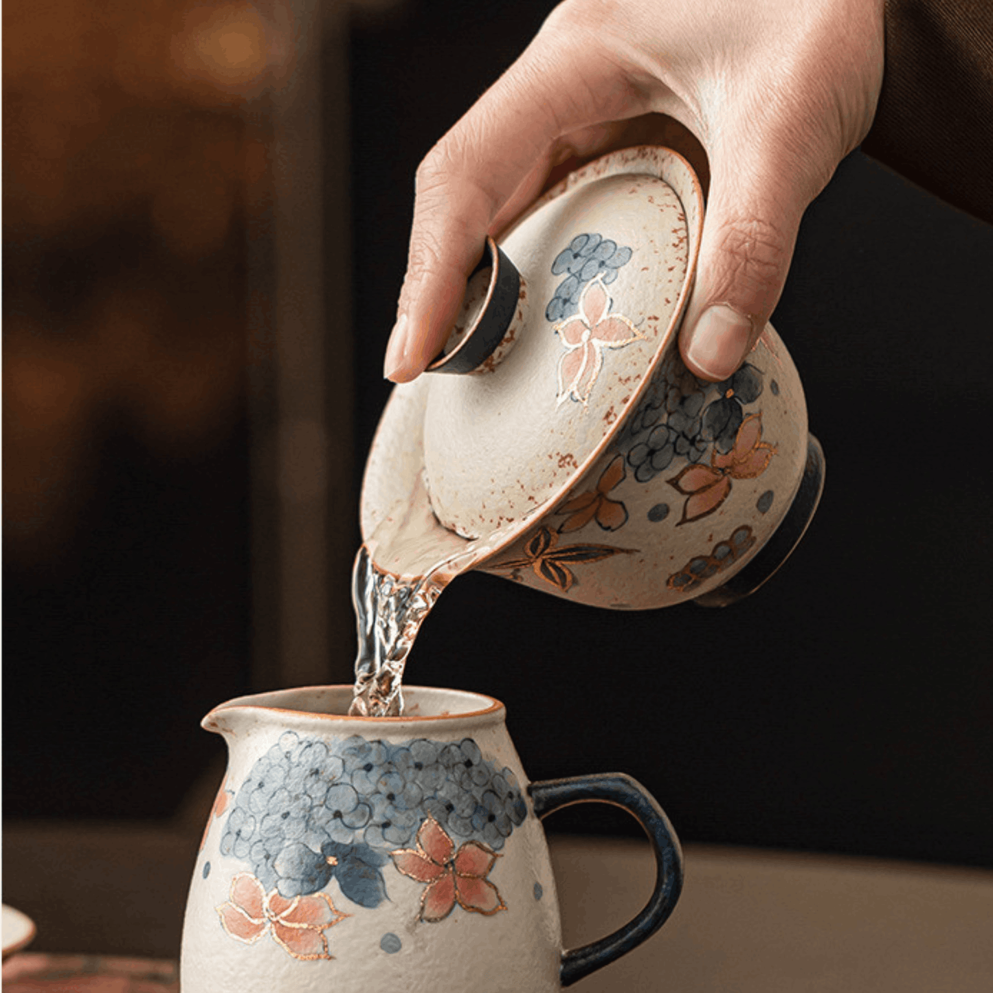 Gaiwan pouring tea into the Gong Dao Bei